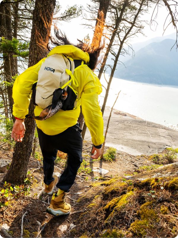 Person hiking wearing HOKA apparel and shoes.